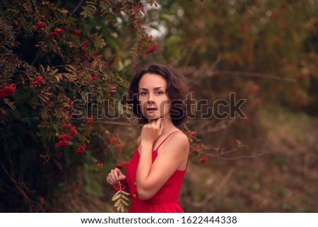 Similar – Melancholic girl with red dress in nature