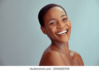 Happy beauty african woman looking at camera isolated on background with copy space. Cheerful mid woman smiling after skin treatment. Beautiful middle aged lady having fun after beauty therapy.