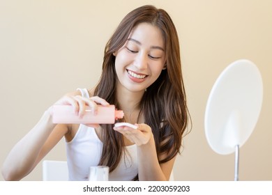 Happy Beauty, Beautiful Asian Young Woman, Girl Looking In To Mirror, Holding Cotton Pad, Applying Facial Wipe On Her Face, Removing Makeup Before Shower In Bathroom, Skin Care On White Background.