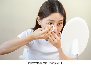 Happy Beauty, Beautiful Asian Young Woman, Girl Looking In To Mirror, Holding Cotton Pad, Applying Facial Wipe On Her Face, Removing Makeup Before Shower In Bathroom, Skin Care On White Background.