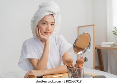 Happy Beauty Blogger Concept, Attractive Asian Young Woman, Girl Smile Make Up Face By Applying Brush Blush On Her Cheek, Looking In The Mirror On Table At Home. People Look With Natural Fashion Style