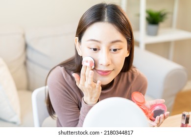 Happy Beauty Blogger Concept, Pretty Asian Young Woman, Girl Make Up Face By Applying Pink Blush By Brush On Cheek, Looking At The Mirror On Table At Home. Female Look With Natural Fashion Style.