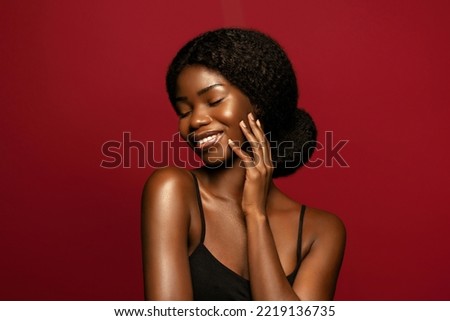 Happy. Beauty portrait of young african american woman posing against red background