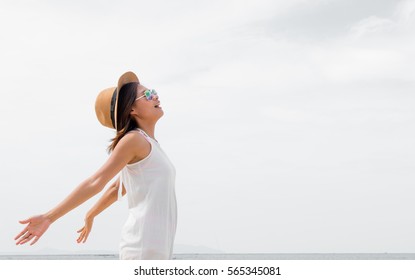 Happy beauty woman in hat is back opened his hands, Beautiful serene relaxing woman in pure happiness and elated enjoyment , Asian Caucasian female model.20-30years - Shutterstock ID 565345081