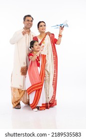 Happy Bengali Family In Traditional Clothing Flying Toy Airplane
