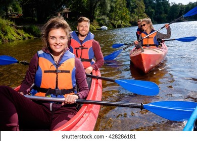 Happy Best Friends Having Fun On A Kayaks