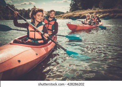 Happy Best Friends Having Fun On A Kayaks