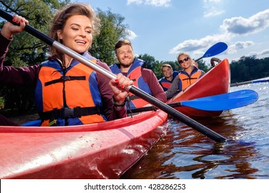 Happy Best Friends Having Fun On A Kayaks