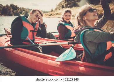 Happy Best Friends Having Fun On A Kayaks