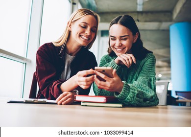 Happy best friends laughing during watching funny videos on internet websites enjoying social media life during break.Two cheerful female bloggers reading positive comments on smartphone device - Powered by Shutterstock