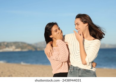 Happy best friends talking and laughing walking on the beach - Powered by Shutterstock