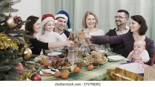 Happy And Big Family Celebrates Christmas At Table In Home