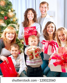 Happy Big Family With Christmas Presents At Home.Christmas Tree. New Year Gifts