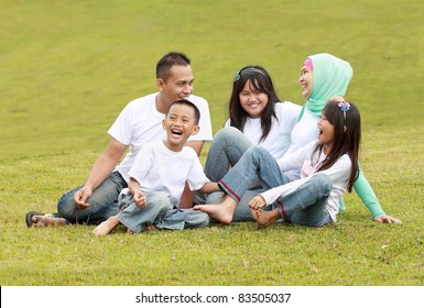 Happy Big Family Having Great Conversation In The Park