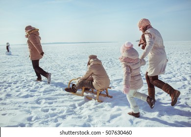 Happy Big Family Walk On A Field In Winter Sunny Day (back View)