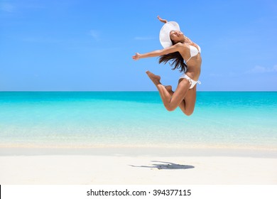 Happy Bikini Woman Jumping Of Joy On Beach. Excited Holiday Girl Doing A Jump Of Freedom And Happiness In A Free Body. Weight Loss Success Healthy Lifestyle Concept.