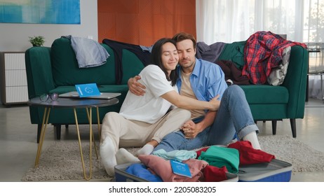 Happy Biracial Homosexual Couple Packing Suitcase For Travel Preparing For Holiday Travel. Diverse Gay Couple Sit On Floor Packing Luggage And Hugging Getting Ready For Honeymoon