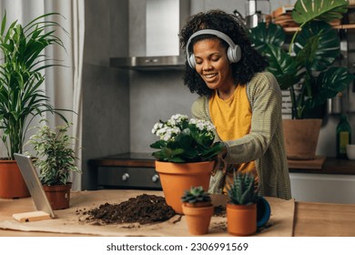 A happy biracial woman works at a flower shop - Powered by Shutterstock