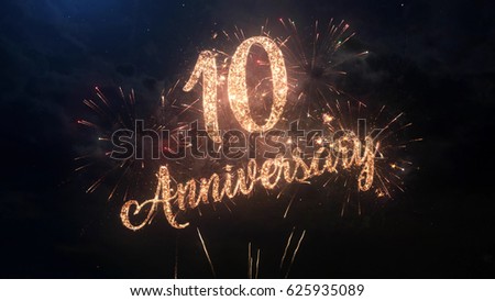 Happy birthday Anniversary 10 years celebration greeting text with particles and sparks on black night sky with colored fireworks on background, beautiful typography magic design.