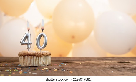Happy birthday card with candle number 40 in a cupcake against the background of balloons. Copy space happy birthday for forty years old - Shutterstock ID 2126049881