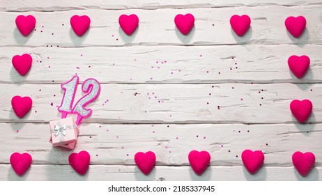 Happy birthday card for a girl in pink shades, top view, copy space. Beautiful congratulations with numbers and hearts, a place for your text. happy birthday candle number 12 - Shutterstock ID 2185337945