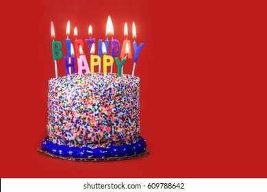 Happy Birthday Celebration Candles on Cake Red Background
