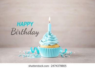 Happy Birthday. Cupcake with candle on table against light background - Powered by Shutterstock