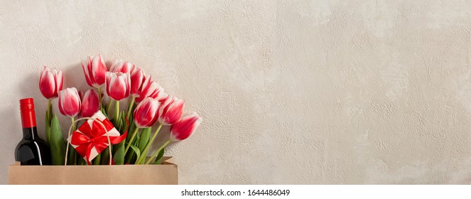 Happy Birthday Greetings Concept. St. Valentine's Day, Mother's Day. Spring Fresh Flowers, Wine, Gift