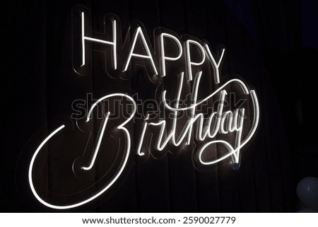 Happy Birthday inscription made of LED strip on a black background. decoration for the holiday.