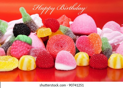 Happy Birthday With A Pile Of Candies On A Red Background