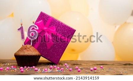Happy birthday with a pink gift box for a 16 year old girl. Beautiful birthday card with a cupcake and a burning candle number sixteen