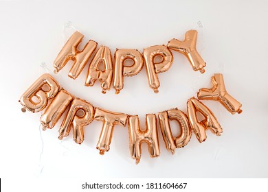 Happy Birthday! Rose Gold Sparkling Balloons On White Background. Celebration Party Anniversary Decoration Composition