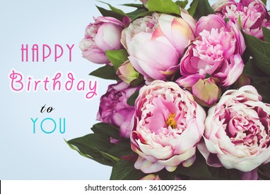 Happy Birthday text card with pink Peony flowers.
Blue background.