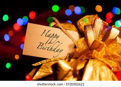  Happy Birthday -text On A Gift Box Label With A Large Gold Bow. 