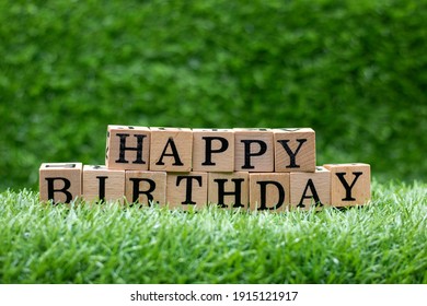 Happy Birthday Wooden Block On Green Grass Background