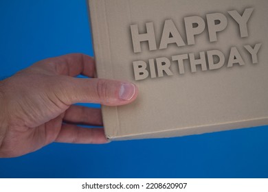 Happy Birthday word with cardboard box. Brown folded card box. - Shutterstock ID 2208620907