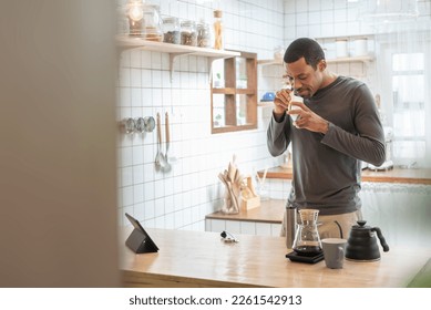 Happy Black African American male making coffee drip in kitchen, Hot drink, Barista at home, Preparing coffee. - Shutterstock ID 2261542913