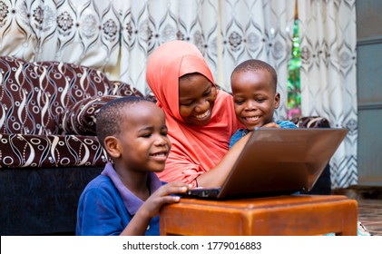 Happy Black African Muslim Single Mother With Two Children Using Modem Technology