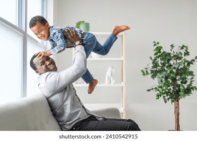 A Happy Black American father with little boy at home - Powered by Shutterstock