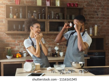 Happy Black Couple Baking Pie And Having Fun In Loft Kitchen. Family Preparing Pastry