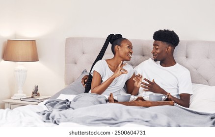 Happy, black couple and breakfast in bed in home for morning conversation, relax and talk. African man, woman and eating healthy food in bedroom with coffee for love, romance or celebrate anniversary - Powered by Shutterstock