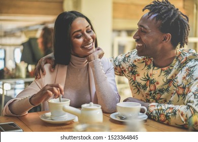 Happy Black Couple Drinking Coffee Inside Vintage Bar Restaurant - Trendy Young People Having Fun Talking And Laughing At Breakfast Time - Love And Lifestyle Concept - Focus On Woman Face