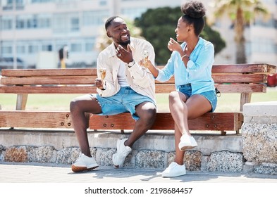 Happy black couple eating ice cream on a beach bench together, smiling while bonding and laughing. Young African American man and woman enjoying their summer romance, free time and relationship - Powered by Shutterstock