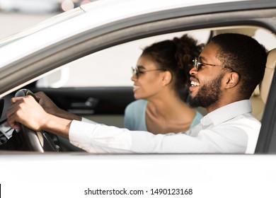 Happy Black Couple Enjoying Road Trip, Sitting In Car And Listening Music, Side View