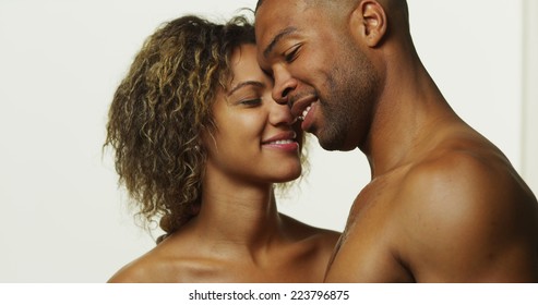 Happy black couple kissing and laughing