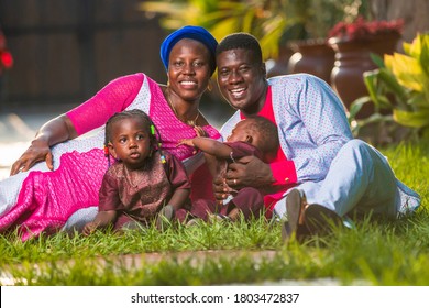 Happy Black Couple And Their Children In African Dresses Outdoor-concept On African Family Health,finance And Investment Advertisement