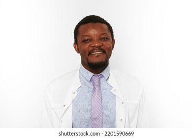 Happy Black Doctor Man With Small Beard In White Coat Bright Shirt Isolated On White Background. Smiling Adult Black African American Physician Therapist Portrait, Pleasant Excited Candid Male Emotion