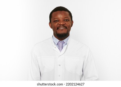 Happy Black Doctor Man With Small Beard In White Coat Bright Shirt Isolated On White Background. Smiling Adult Black African American Physician Therapist Portrait, Pleasant Excited Candid Male Emotion