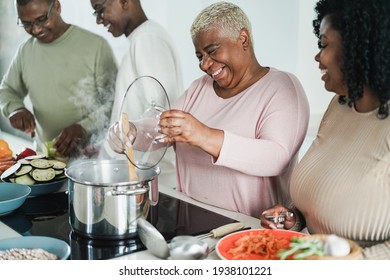 Happy Black Family Cooking Inside Kitchen At Home - Father, Daughter, Son And Mother Having Fun Preparing Lunch - Main Focus On Mum Face