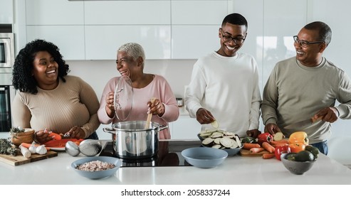 Happy Black Family Cooking Inside Kitchen At Home - Soft Focus On Boy Face